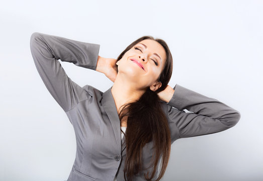 Beautiful Business Woman Waking Up In The Morning With Happy Face And Doing Lazy Stretching To Her Back And Arms On Blue Backround. Closeup