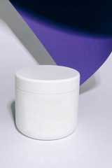 white jar of cream on a white background