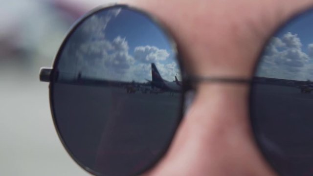 Airplanes Reflected in the Dark Sunglasses