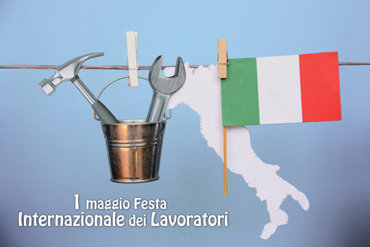 1 MayInternational Workers labor day text in italian. italy flag, hammer and wrench - grunge abstract image