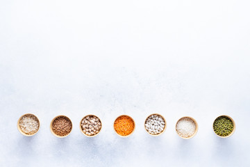 Dry bio cereals in craft bio cups made of paper on a gray background. Concept of healthy food with home delivery. Top view, Copy space.