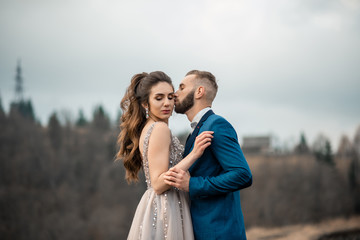 wedding couple. Beautiful bride and groom. Just merried. Close up. Happy bride and bearded groom on their wedding hugging. wedding dress. Lifestyle concept.