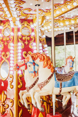 Carousel with horses. Bright swing for children. Amusement park