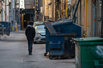Man walking down a painted alley in Toronto.