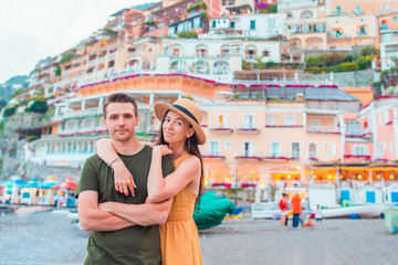 Fototapeta na wymiar Summer holiday in Italy. Young couple in Positano village on the background, Amalfi Coast, Italy