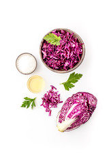 Red cabbage - cut head and sliced - on white kitchen table top view