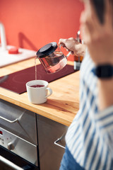 Caucasian girl talking on mobile phone in kitchen at home