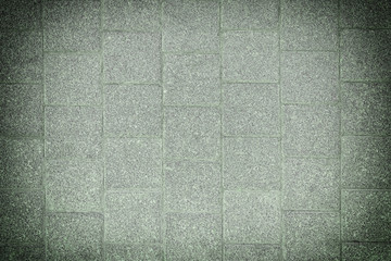 Toned photo of stone paving slabs. Green background with vignette for sites and layouts