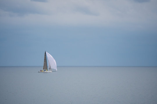 Sailboat Sailing In Sea Against Sky