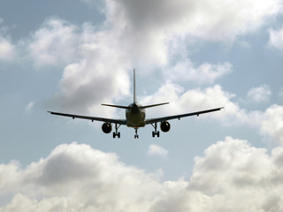 plane taking off into the sky with dense clouds
