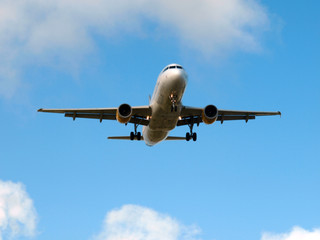 plane landing on a sunny day with blue sky