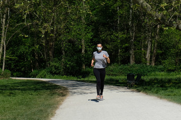 Woman running during coronavirus pandemic with face mask