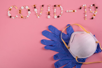 on a pink background of a tablet is the word laid out, the inscription is written covid-19,...