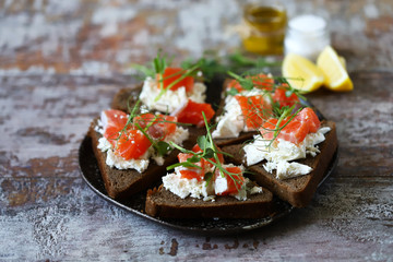 Selective focus. Macro. Healthy toasts with salmon and microgreens.