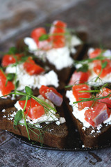 Selective focus. Macro. Healthy toasts with salmon and microgreens.