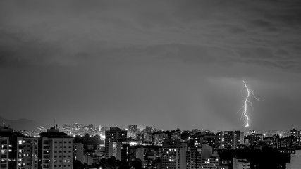 Imagens da chegada de uma tempestade de verão com raios e chuva, na cidade durante a noite em...