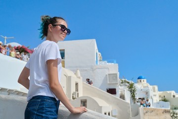 Fototapeta na wymiar Beautiful happy girl tourist on island of Santorini in Greece