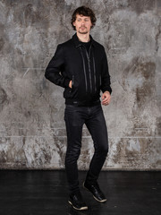 Full length studio portrait of attractive young man. Young Male Fashion Model Posing In Casual Outfit. 