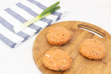 Raw minced meat meatballs on the wooden board ready for frying