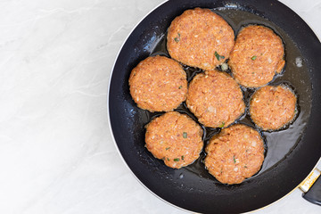 Frying meatballs in the frying pan with copy space