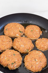 Frying meatballs in the frying pan