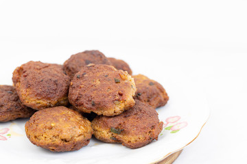 Fried meatballs served on the plate with white background and copy space