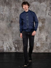 Full length studio portrait of attractive young man. Young Male Fashion Model Posing In Casual Outfit. 