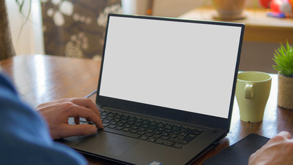 Close up of male hands and laptop with blank screen. Mock-up of computer monitor. Copyspace ready...