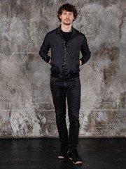 Full length studio portrait of attractive young man. Young Male Fashion Model Posing In Casual Outfit. 