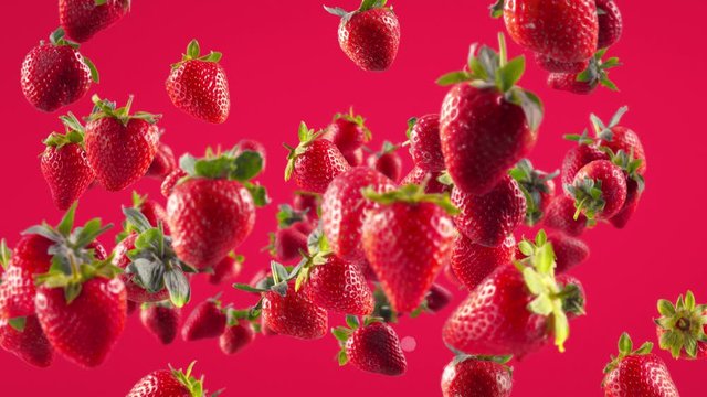 Flying of Strawberry in Fuchsia Background