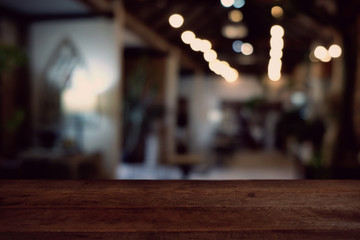 wood table on blur of cafe, coffee shop, bar, resturant, background - can used for display or montage your products