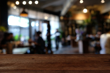 wood table on blur of cafe, coffee shop, bar, resturant, background - can used for display or montage your products