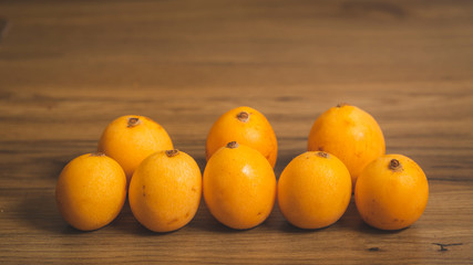 8 medlars with wood background