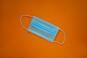 Coronavirus prevention face mask. Social distance, self-isolation during quarantine Covid-19. Safety breathing mask layout, top view, flat lay.