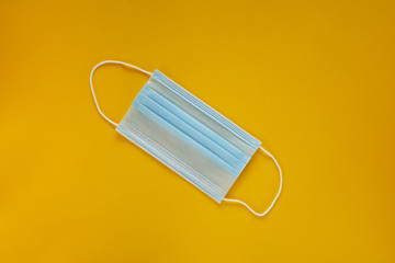 Coronavirus prevention face mask. Social distance, self-isolation during quarantine Covid-19. Safety breathing mask layout, top view, flat lay.