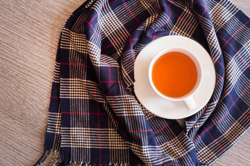 Top view of a hot tea on a blue scarf over a table
