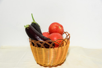 Closeup of fresh ripe vegetables isolated on white background in basket, healthy eating