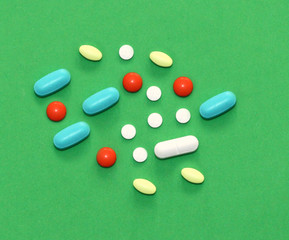 Colorful pills and drugs in close up. Assorted pills and capsules in medicine. drugs of various kinds and different colors. Medicine on yellow background.