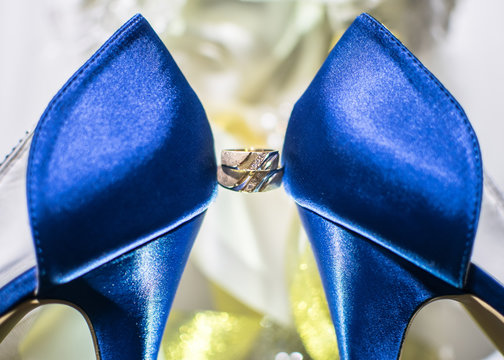 wedding rings on blue wedding shoes