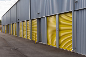 row of yellow loading doors at a storage facility
