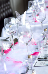 Wedding table setup with wine glasses and petals