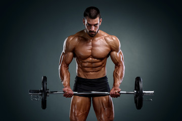 Fototapeta na wymiar Strong Muscular Men Lifting Weights. Bodybuilder Doing Bicep Curls Exercise