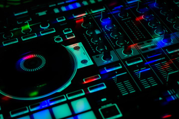 DJ Jog wheel Sliders & Knobs of Colorful DJ Controller in club party