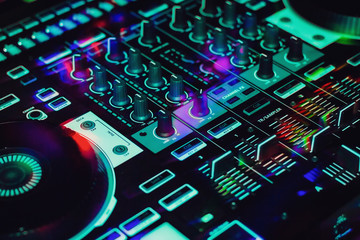 Colorful Mobile DJ Controller in club showing four deck mixer
