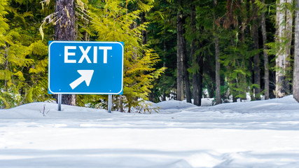 Exit Traffic Sign at the Snow Covered Parking Lot of Spahats Falls in Wells Gray Provincial Park in the Cariboo Mountains of British Columbia, Canada