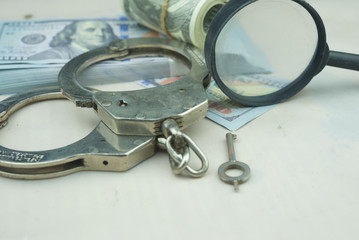 Fraud concept.Police handcuff with banknote.