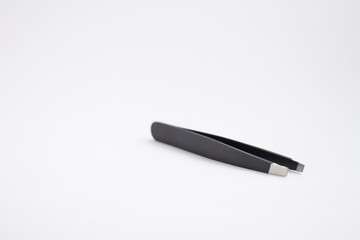 black epilating tweezers on white background
