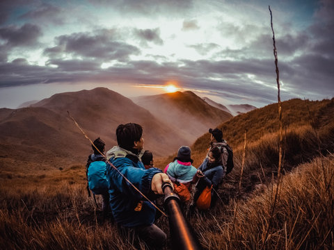 hikers in the mountains witnessing sunrise in Mt. Pulag in the Philippines.
