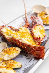 Assortment of baked seafood with cream and cheese on a Metallic plate