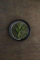 Japanese green tea in a bowl on a dark wooden table 